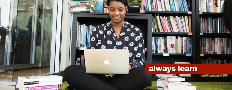 Seated Woman Working On IMac Computer